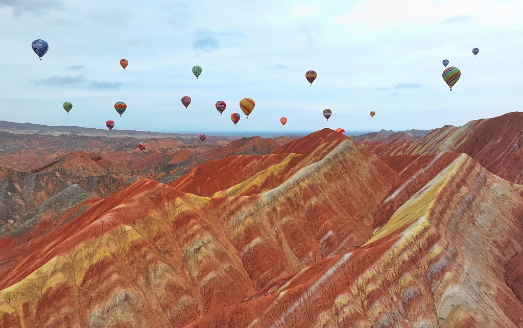 Drift away over a colorful Danxia landscape